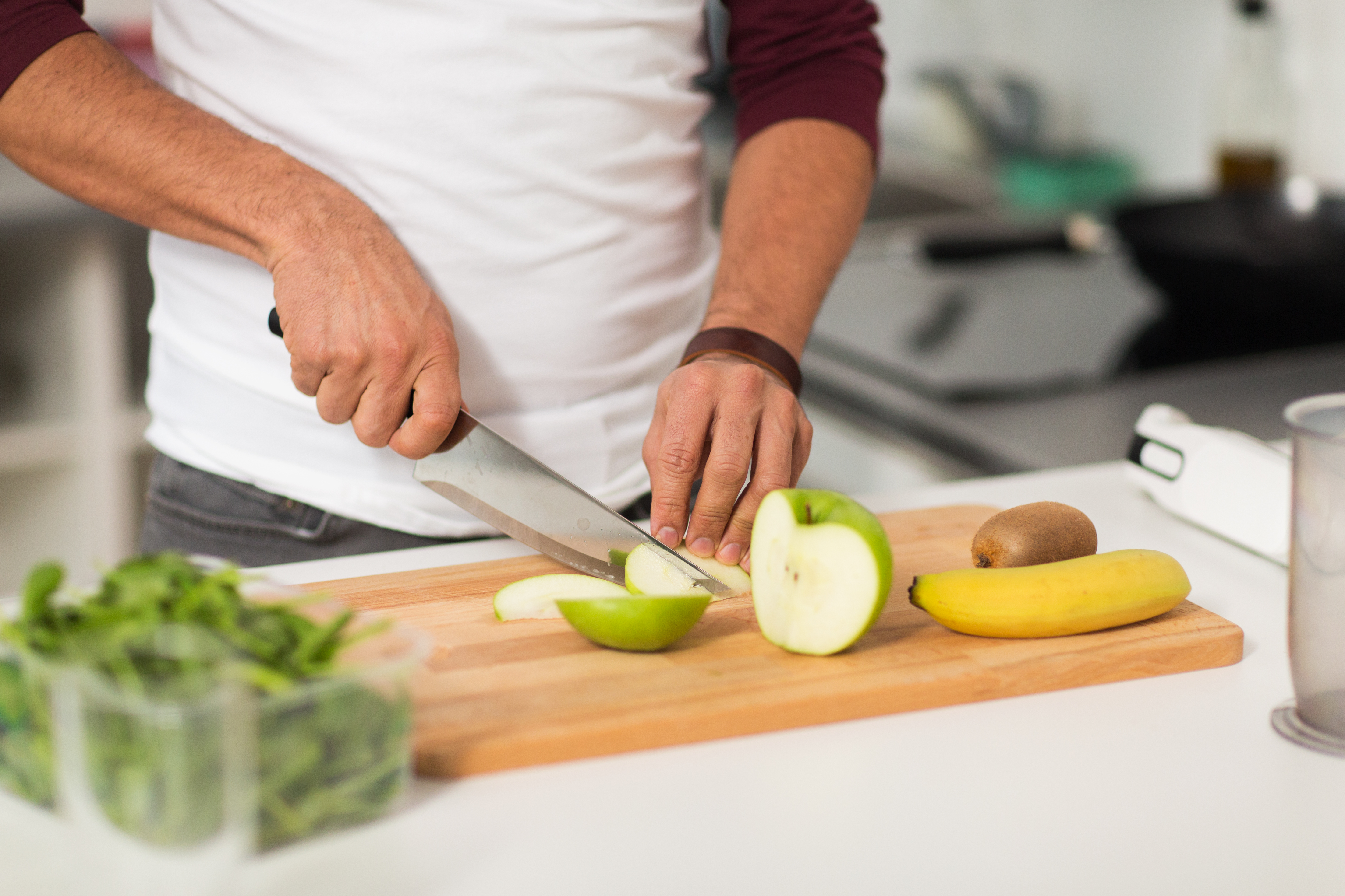 man chopping fruit