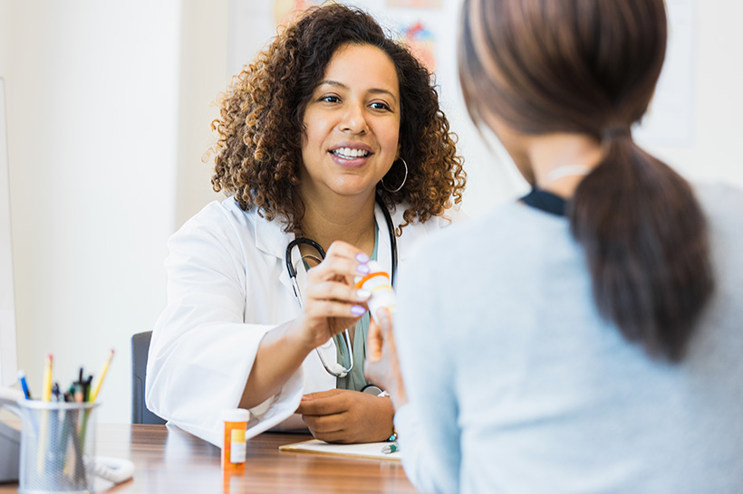 provider assisting patient with medication management