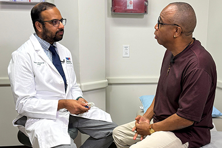 Dr. Utsav Bansal with Burley in exam room